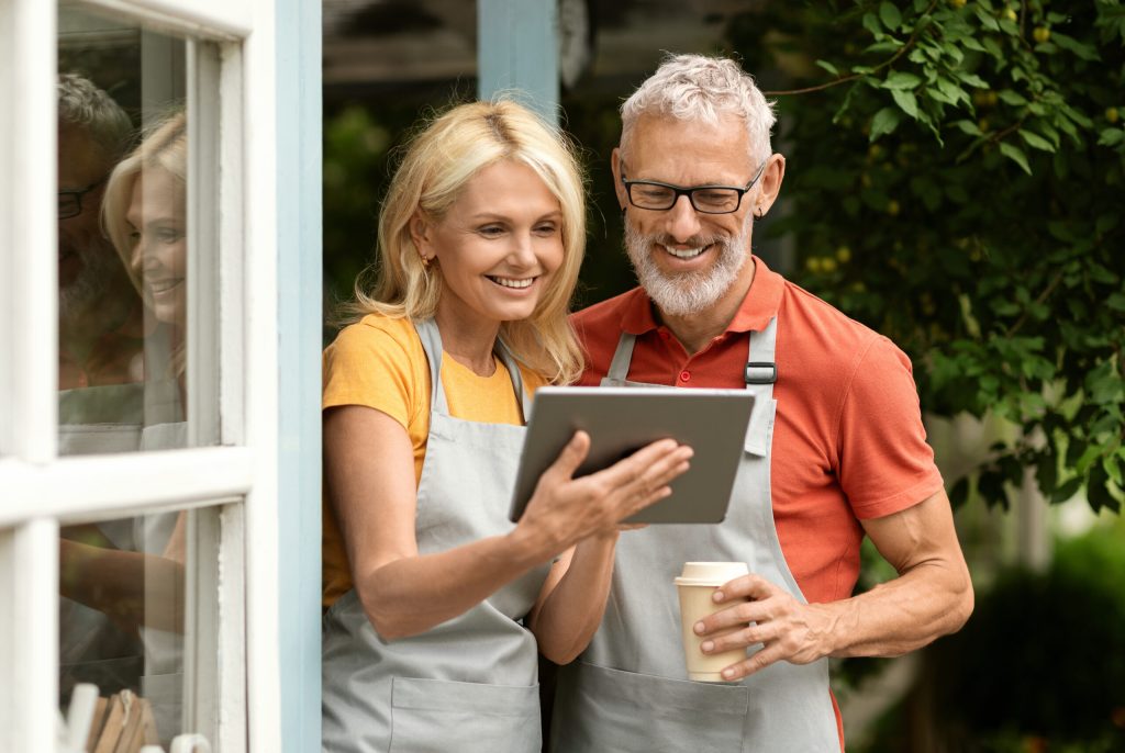 an older couple views a tablet device together